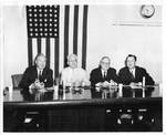 Eastland at table with three unidentified men in front of an American flag during Senate Subcommittee Hearing at Florida Citrus Mutual by Perkins Bro'-Duane (Lakeland, Fla.)