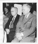 Eastland seated with an unidentified man at a Citizens Council rally where Eastland linked school integration with a communist plot to degrade American training of future scientists. by Author Unknown