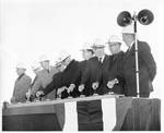 Eastland with a group of men in hardhats pushing buttons at the Okatibbee Reservoir groundbreaking ceremony in Meridian, Mississippi. by Author Unknown