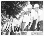 Eastland in hard hat with unidentified men in hard hats at Water Way and Soil Conservation Opening Day. by Itawamba County Times (Fulton, Miss.)