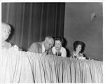 Eastland with Mrs. Paul Johnson, Mrs. Eastland, and an unidentified woman dining at banquet honoring Paul Johnson by Author Unknown