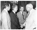 Eastland shaking hands with Jimmy Carter with unidentified men also pictured by Author Unknown