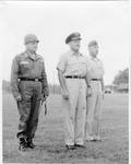 General Claude F. Clayton and two unidentified officers standing outside by Author Unknown