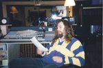 Recording studio, Dave Woolworth seated at mixing board by Kudzu Kings (Musical Group)