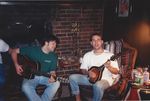 Playing guitar and mandolin in front of a fireplace by Kudzu Kings (Musical Group)