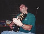 Playing guitar in front of a fireplace by Kudzu Kings (Musical Group)