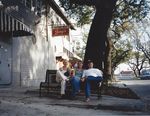 Two women, Tate, on shady bench outside Tipitina's by Kudzu Kings (Musical group)