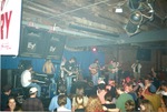 On stage in a smoky venue, view from crowd