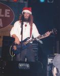 Dave Woolworth, playing bass guitar, Santa hat by Kudzu Kings (Musical Group)