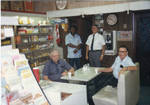 John Leslie and group; interior of Leslie Drugstore. by Author Unknown