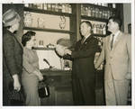 John Leslie, Dean Hammoud, and others inside Leslie Drugstore. by Author Unknown