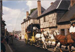 Horse drawn carriages participating in Bastille Day. by Author Unknown