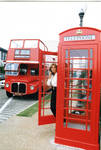 Woman posing in front of Oxford's double decker tour bus and phone box, image 003 by Author Unknown
