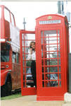 Woman posing in front of Oxford's double decker tour bus and phone box, image 005 by Author Unknown