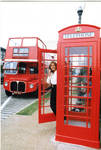 Woman posing in front of Oxford's double decker tour bus and phone box, image 006 by Author Unknown