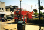People between the double decker tour bus and phone box. by Author Unknown