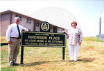 John Leslie and woman at the dedication of Riverside Place housing complex. by Author Unknown
