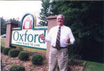 John Leslie in front of new Oxford welcome sign, image 001 by Author Unknown