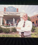 John Leslie in front of Baptist Memorial Hospital North Mississippi, image 002 by Author Unknown