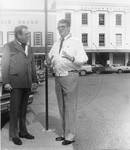 John Leslie and Stuart Easman in front of Leslie Drugstore. by Author Unknown