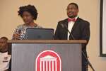 Kadijah Abston and male student at podium look to their right, horizontal by Mississippi Alliance for Minority Participation