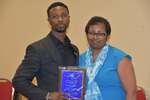 Malcolm McNair poses with plaque and Ms. Vinson by Mississippi Alliance for Minority Participation