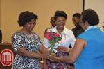 Kadijah Abston and female student present flowers to Ms. Vinson by Mississippi Alliance for Minority Participation