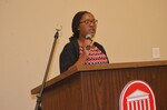 2015. Female student stands at podium by Mississippi Alliance for Minority Participation
