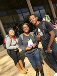 Three students pose with coupon booklets by Mississippi Alliance for Minority Participation