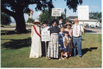 Group of people dressed in costumes and holding suffrage signs, image 1 by Author Unknown