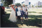 Group of people dressed in costumes and holding suffrage signs, image 2 by Author Unknown