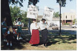 Two women holding signs by Author Unknown