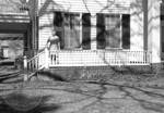 Unidentified woman standing on front porch at Rowan Oak: Image 1 by Edwin E. Meek