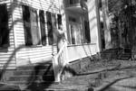 Unidentified woman standing on front porch at Rowan Oak: Image 4 by Edwin E. Meek