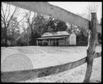View of stable through fence at Rowan Oak by Edwin E. Meek