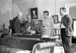Four unidentified people talking in living room at Rowan Oak: Image 2 by Edwin E. Meek