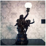 Lamp with cherubs at Rowan Oak by Edwin E. Meek