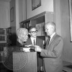Jim Webb and unidentified man standing next to bust of William Faulkner: Image 7 by Edwin E. Meek