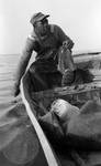 African American man fishing on boat: Image 1 by Edwin E. Meek