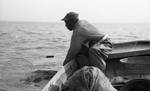 African American man fishing on boat: Image 2 by Edwin E. Meek