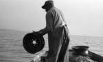 African American man fishing on boat: Image 3 by Edwin E. Meek