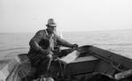 White man steering boat by Edwin E. Meek