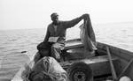 African American man fishing on boat: Image 2 by Edwin E. Meek
