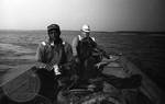 African American man and white man trolling in fishing boat: Image 1 by Edwin E. Meek