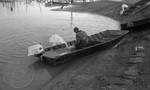 White man in flooded fishing boat at Hurricane Landing: Image 2 by Edwin E. Meek