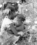 African American child with baby in cotton field by Edwin E. Meek