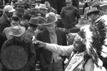 Native American man (Choctaw) in regalia sells medicine to crowd: Image 2 by Edwin E. Meek