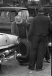 Men examining tire by Edwin E. Meek