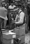 Native American man (Choctaw) in regalia sells medicine to crowd: Image 7 by Edwin E. Meek