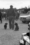 Man walking with two dogs by Edwin E. Meek